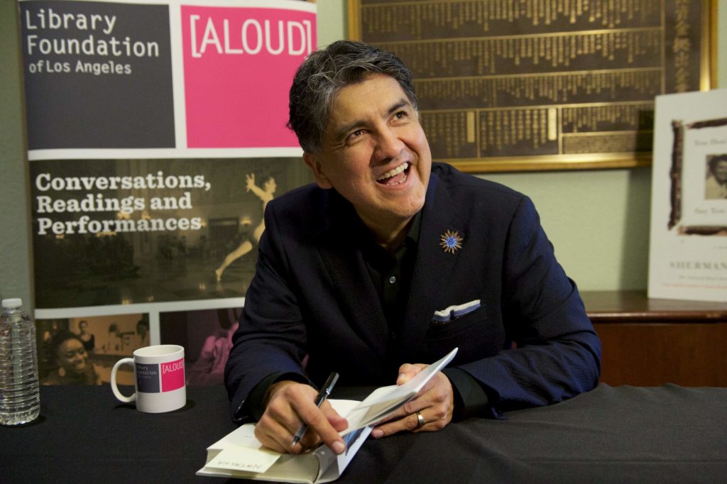 Sherman Alexie signs books after his reading and performance.